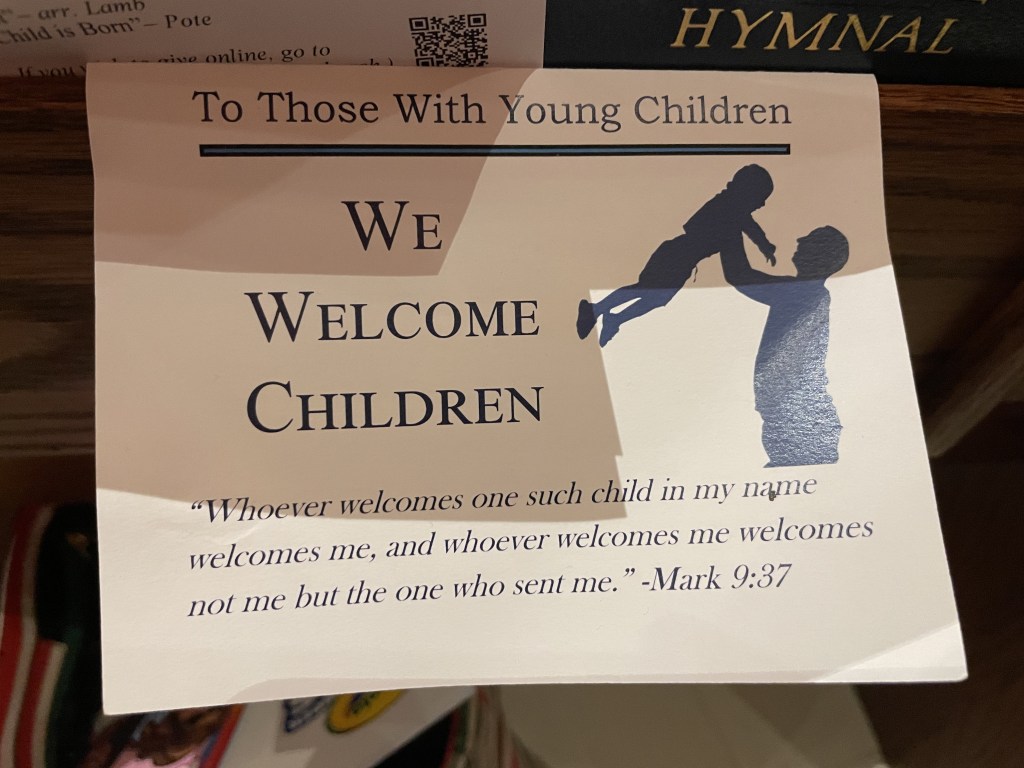 Card sitting in church pew with icon of adult and child and words To Those With Young Children
We Welcome Children
Whoever welcomes one such child in my name welcomes me, and whoever welcomes me welcomes not me but the one who sent me.
Mark 9:37